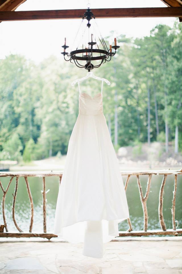 Brides dress hanging to a chandelier
