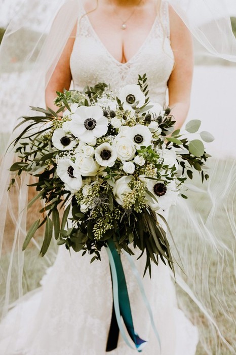 Bride standing and holding white flowers
